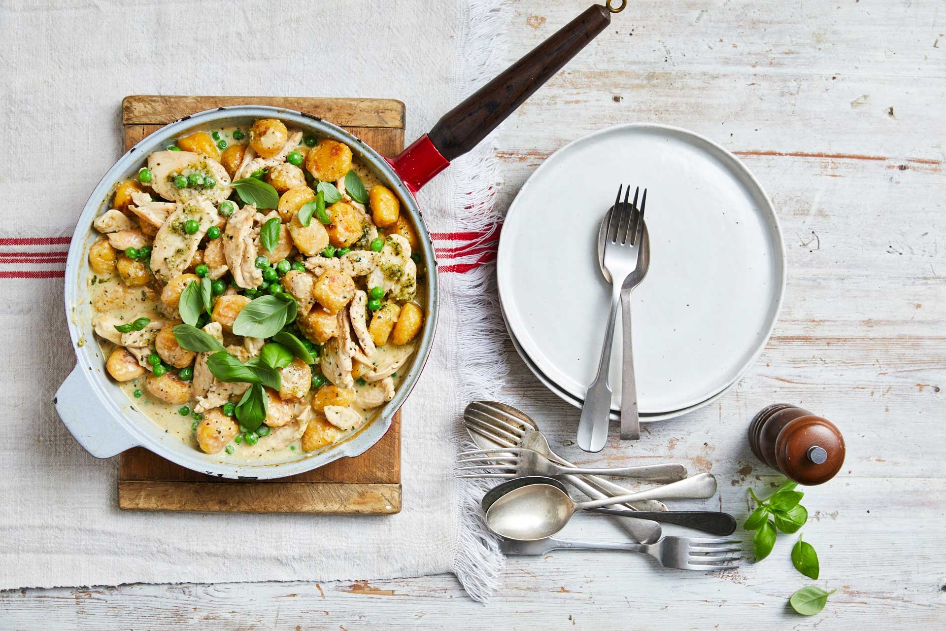 A delicious pan of food with savoury tender chicken and colorful vegetables with gnocchi, cooked to perfection.