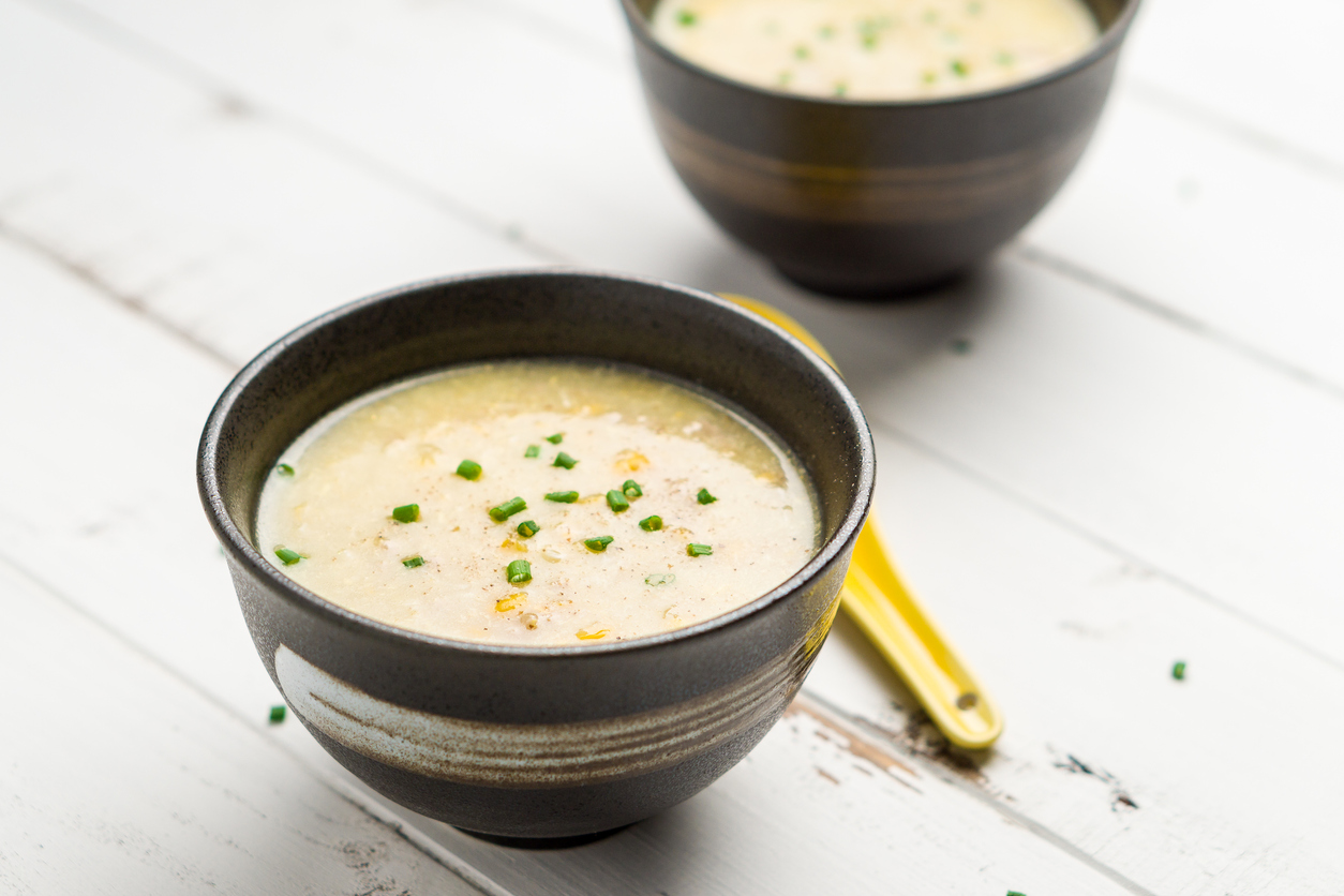 Two bowls of soup placed on a white table