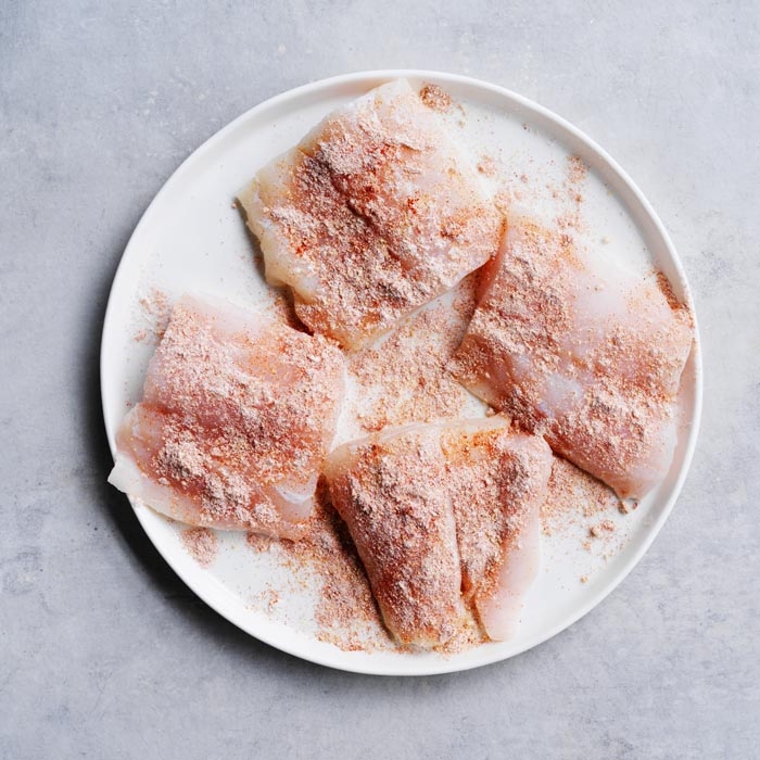 Seasoning fish with spices