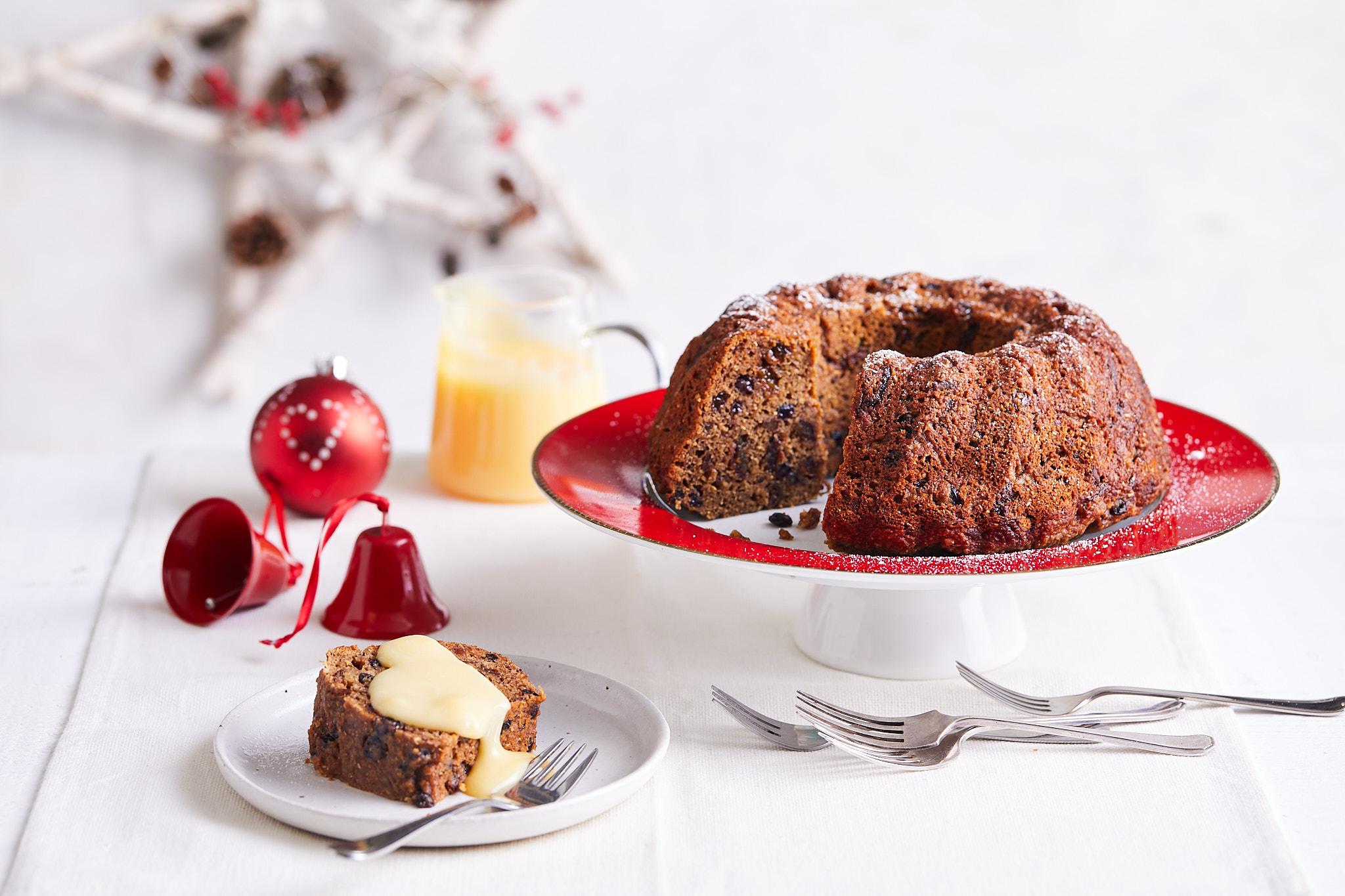 A delectable cake on a plate, accompanied by a knife and fork