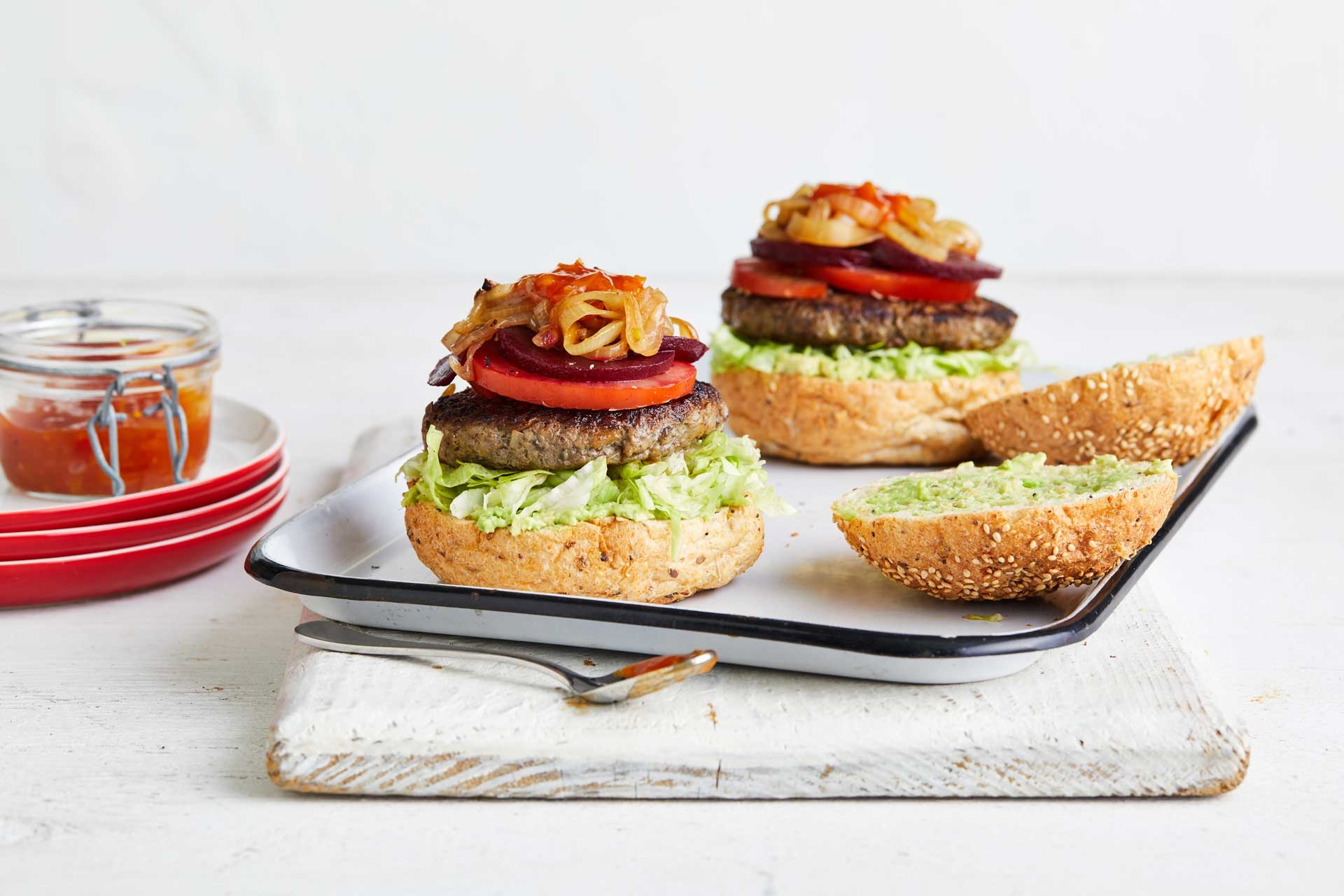 Beef burgers opened up on platter with chutney on the side