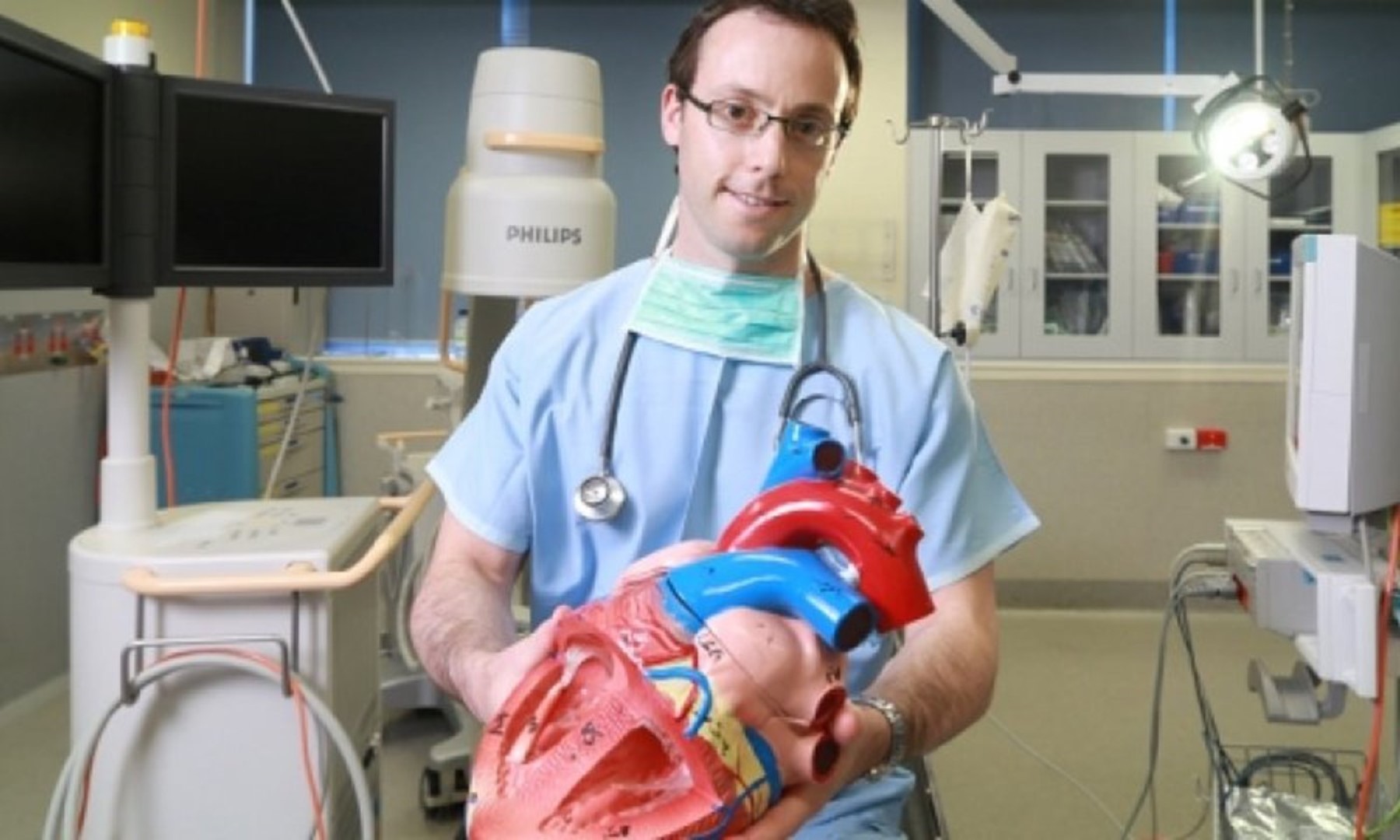 Dion Stub in light blue scrubs smiling at the camera