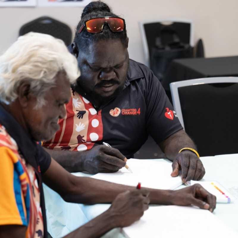 Two First Nations men writing down notes at a Champions4Change workshop