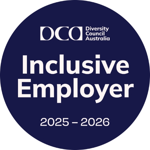 A circular badge with a dark blue background featuring the logo and text of Diversity Council Australia. The text reads: “Inclusive Employer 2025 – 2026” in large white letters, with “Diversity Council Australia” in smaller text at the top.
