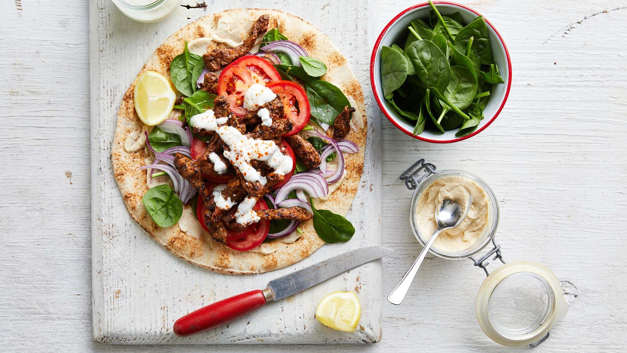 mouthwatering souvlaki featuring lamb, colorful vegetables, and salad