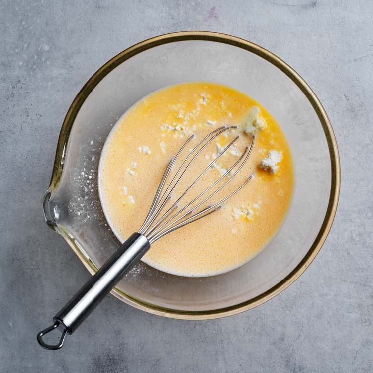 Eggs and ricotta whisked in a bowl
