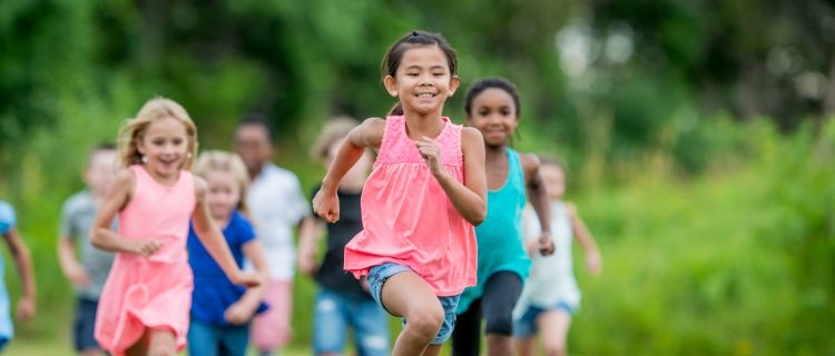 A group of young people running around outside