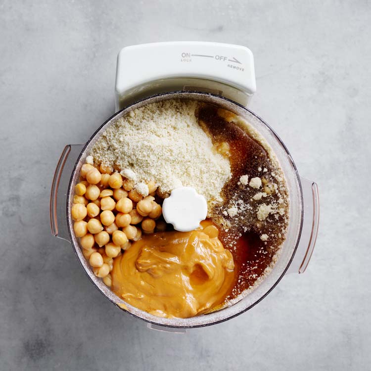 Chickpeas, almond meal, peanut butter, maple syrup and vanilla added to the food processor