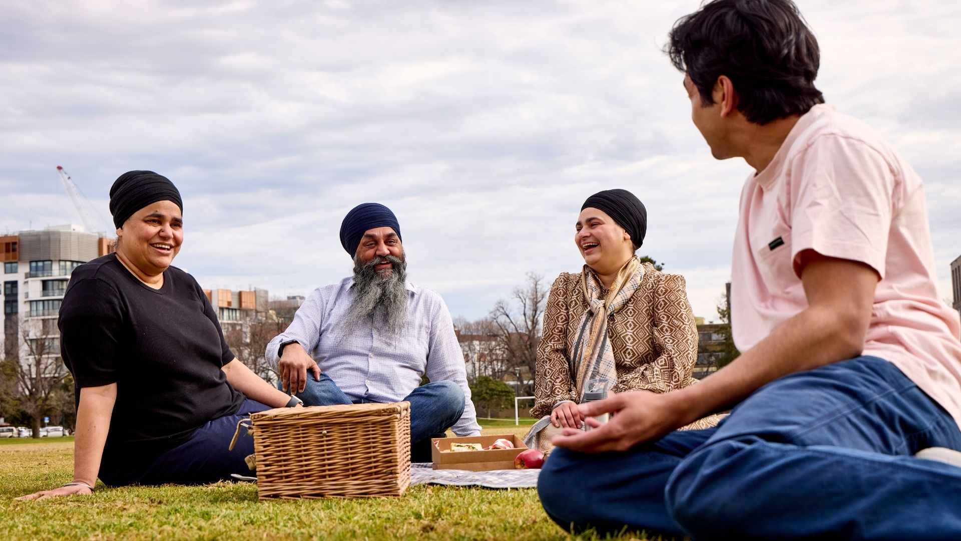 An Indian family sitting at the park