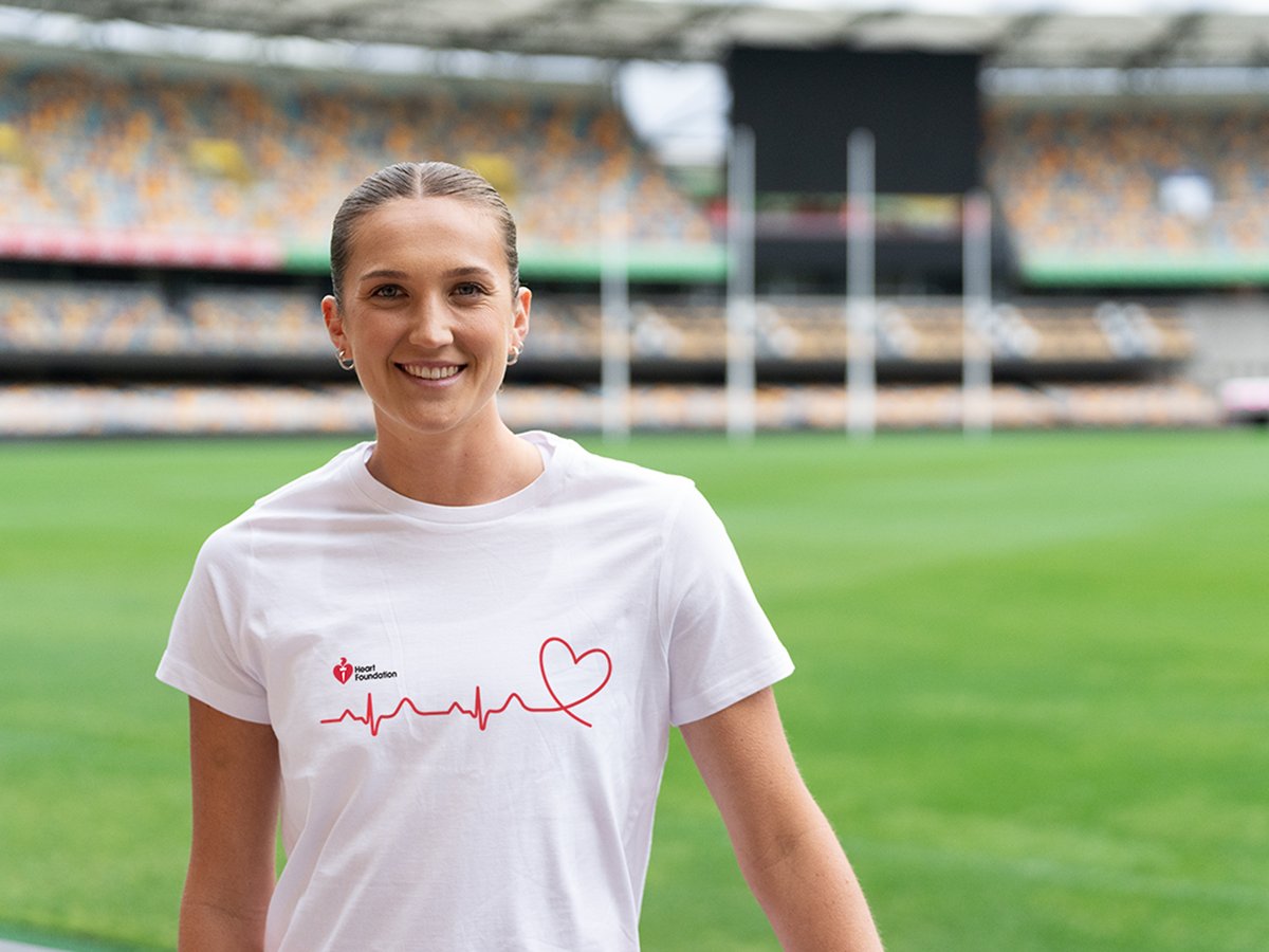 AFLW player Tay Smith smiling while wearing a heart foundation top