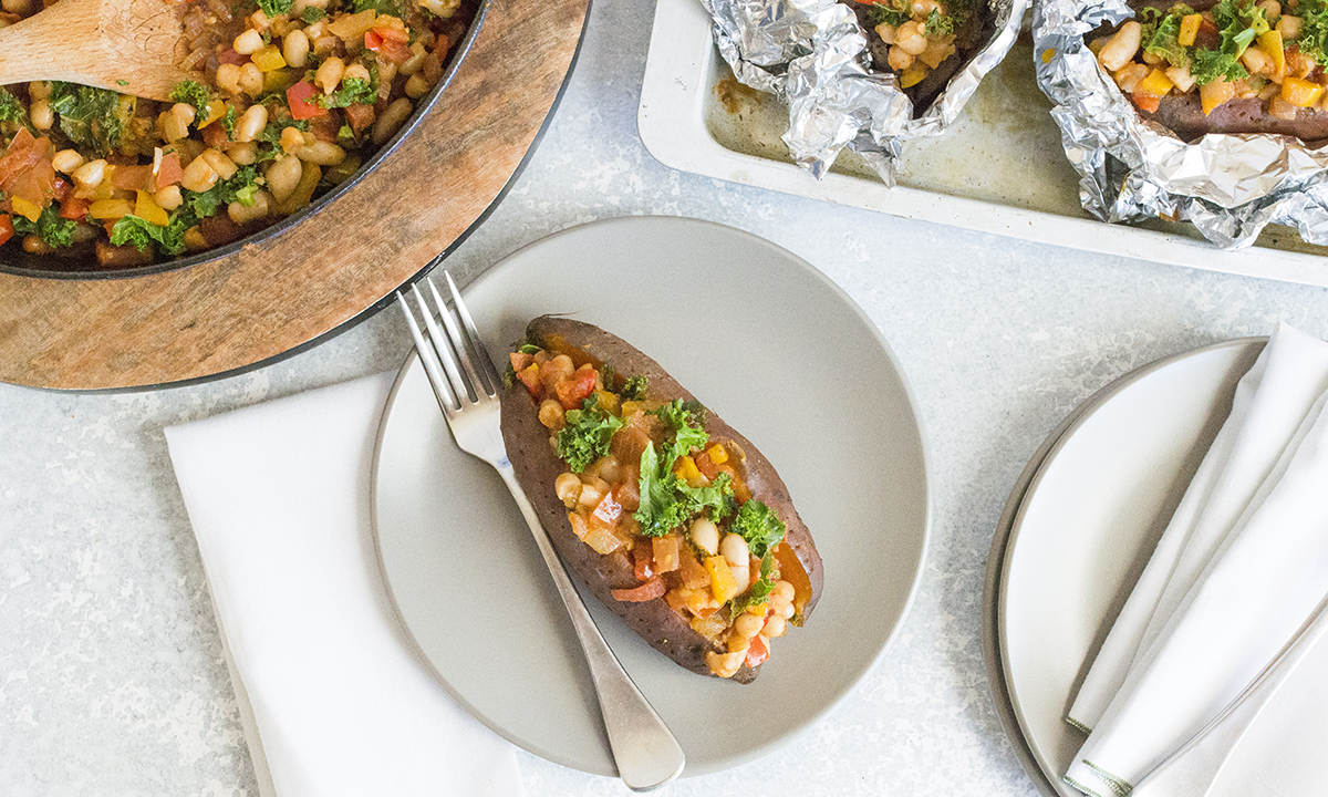 A plate showcasing a baked potato alongside a medley of fresh vegetables.