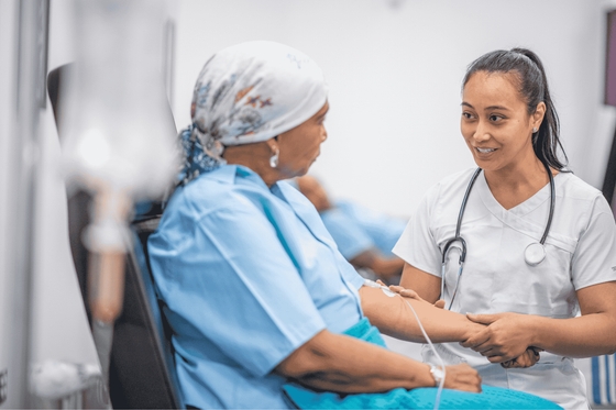 An oncology nurse talking with a cancer patient about heart health.