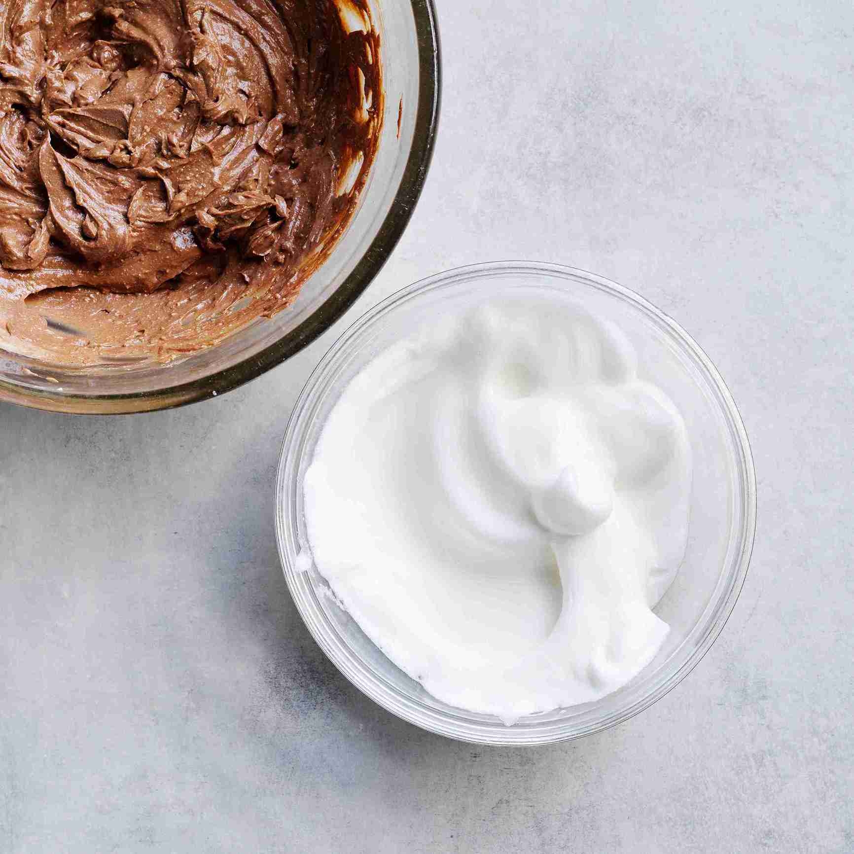 egg whites and icing sugar being beaten to firm peaks with an electric mixer