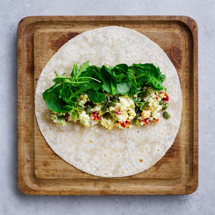 Egg mixture spooned across the centre of wraps and topped with leaves