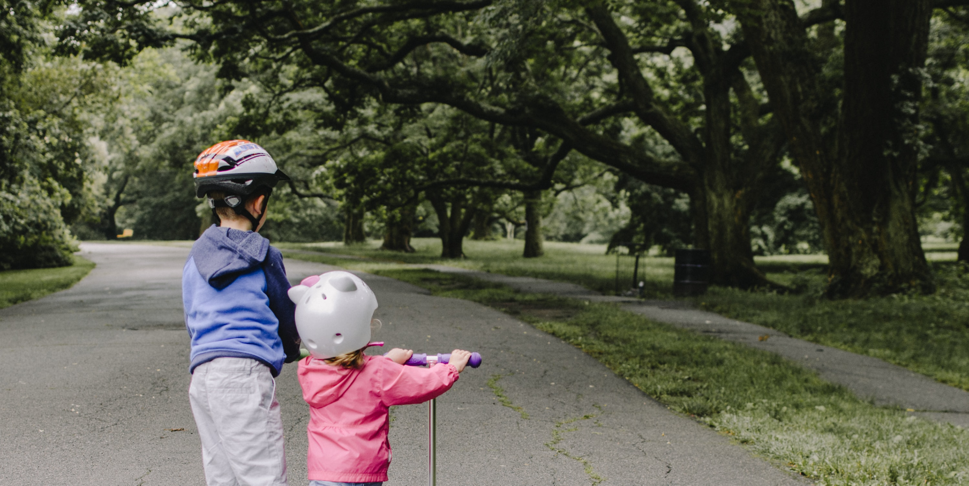 two children riding scooter