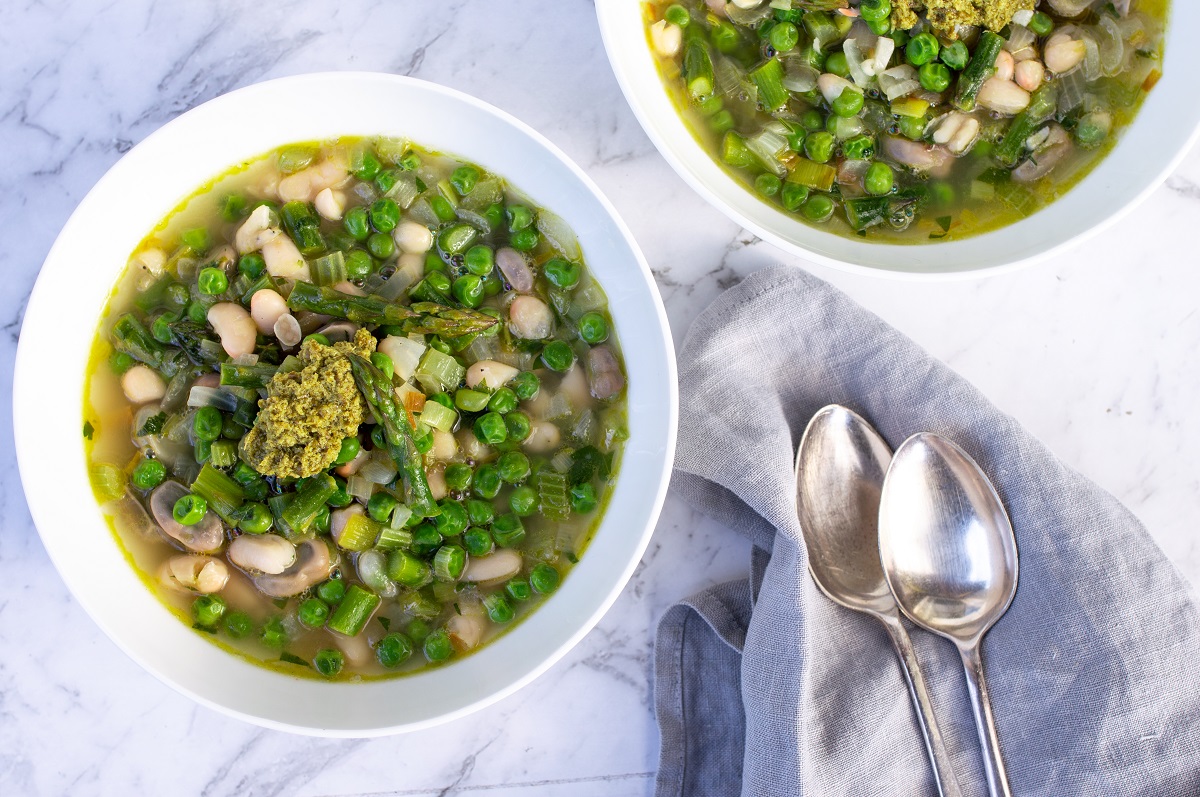  Two bowls of soup with peas, mushrooms and herbs