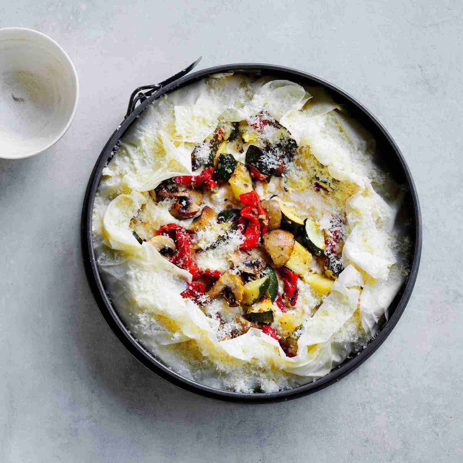 baked tart cooling in pan, served with tomatoes, onions, parsley and balsamic glaze