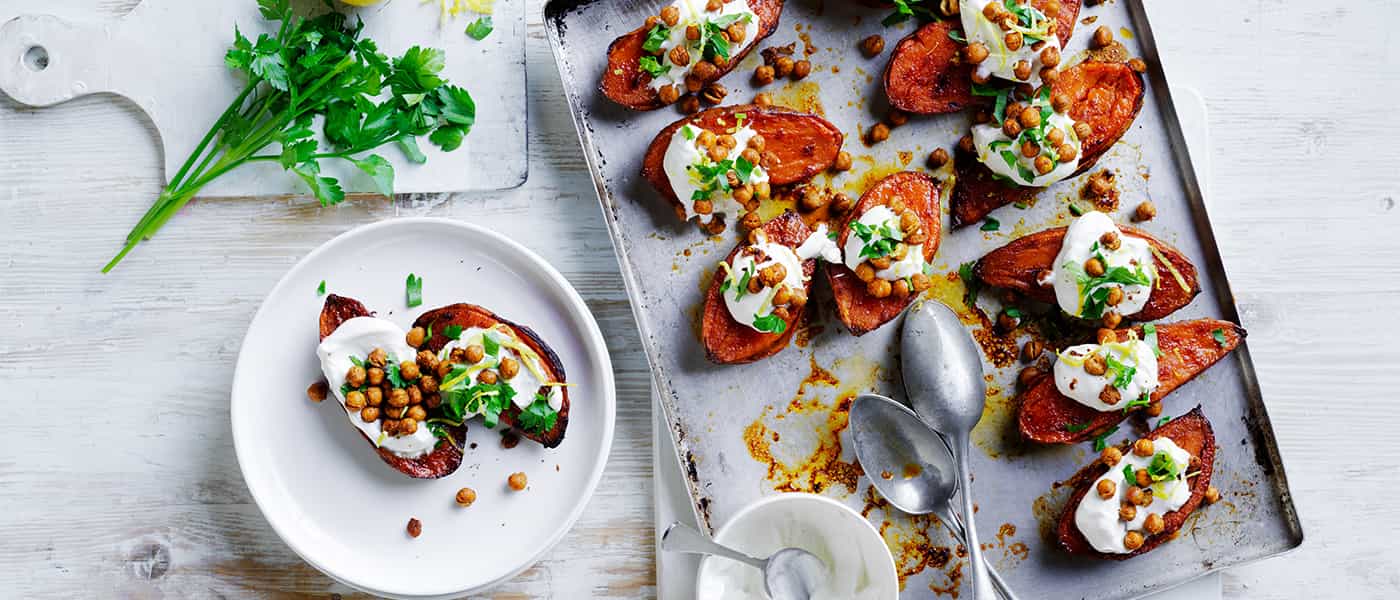 A delectable dish of sweet potatoes, chickpeas, and yogurt, perfectly cooked and garnished, ready to be savored.