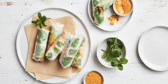 A delectable appetizer consisting of fresh vegetables, herbs, rice noodles and protein wrapped in rice paper, served with a rich and creamy peanut sauce.