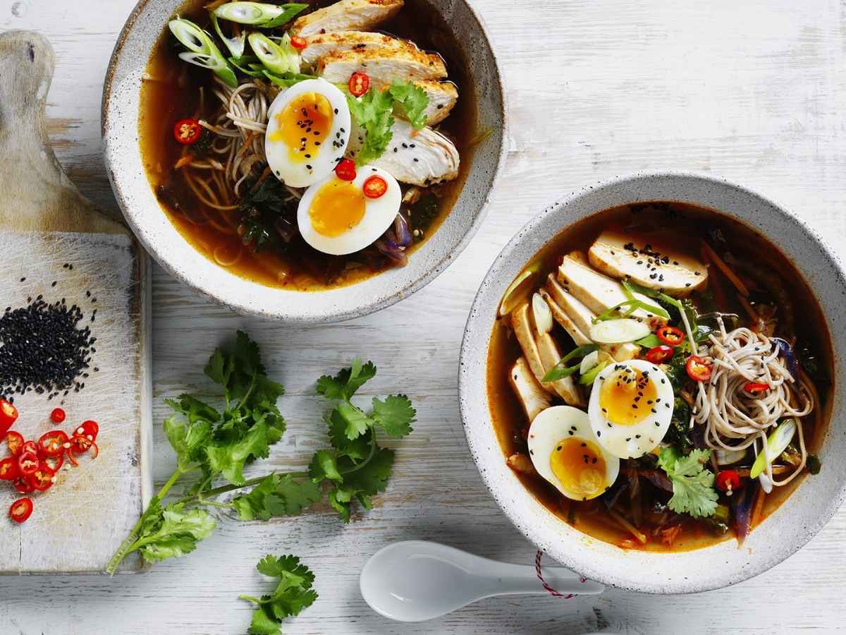 Thai-inspired chicken ramen served in a bowl with noodles, chicken and vegetables