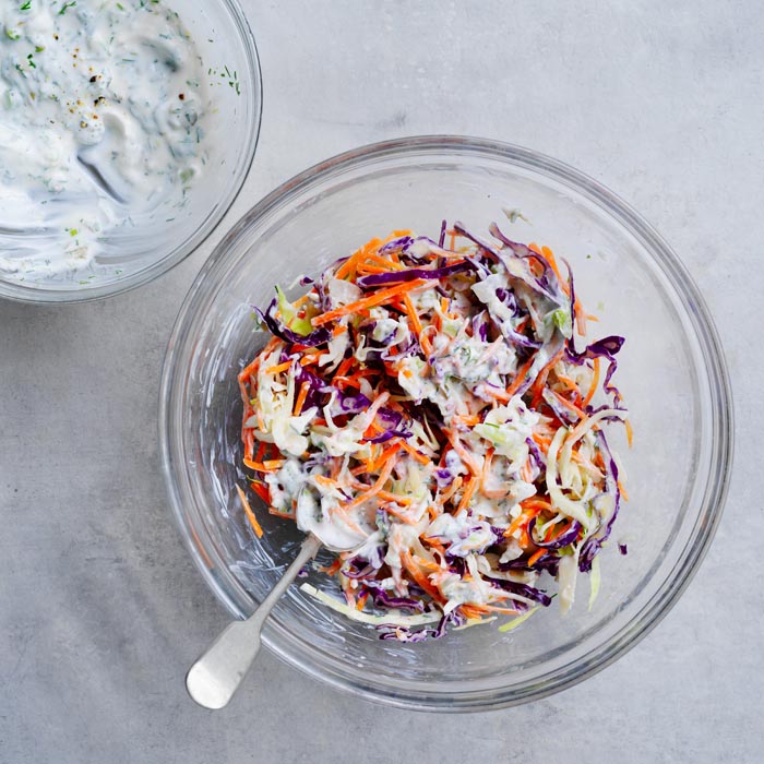 Mixing coleslaw with dressing