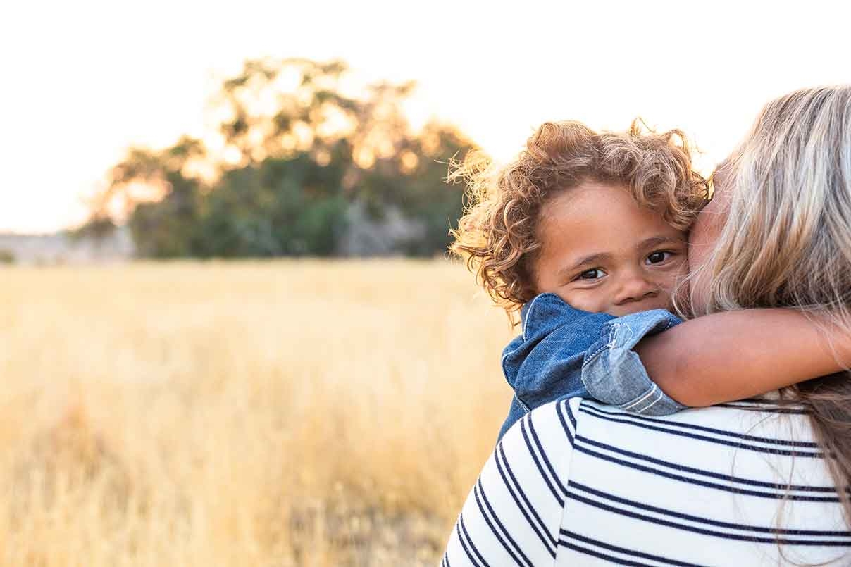 young boy hugging his mother