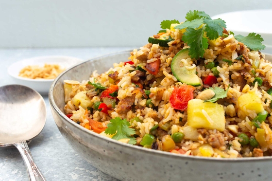 Pork and pineapple fried rice served with coriander garnish on a plate