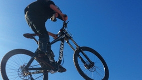 Someone on a bike shot from below blue sky in background