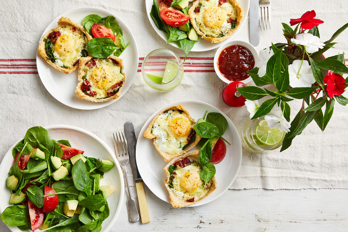 A table adorned with four plates of delectable tarts