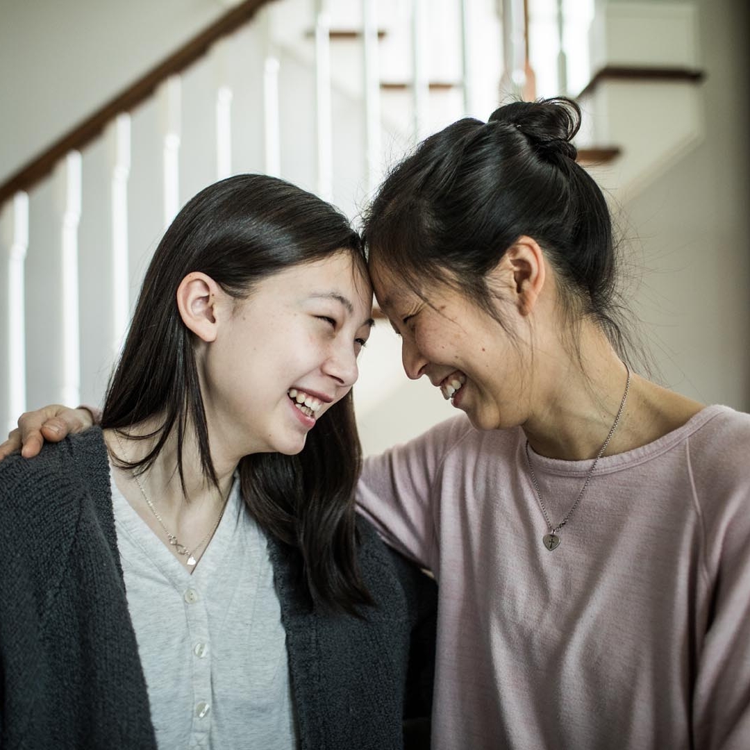 A mother with her daughter sharing a warm and intimate bonding time.