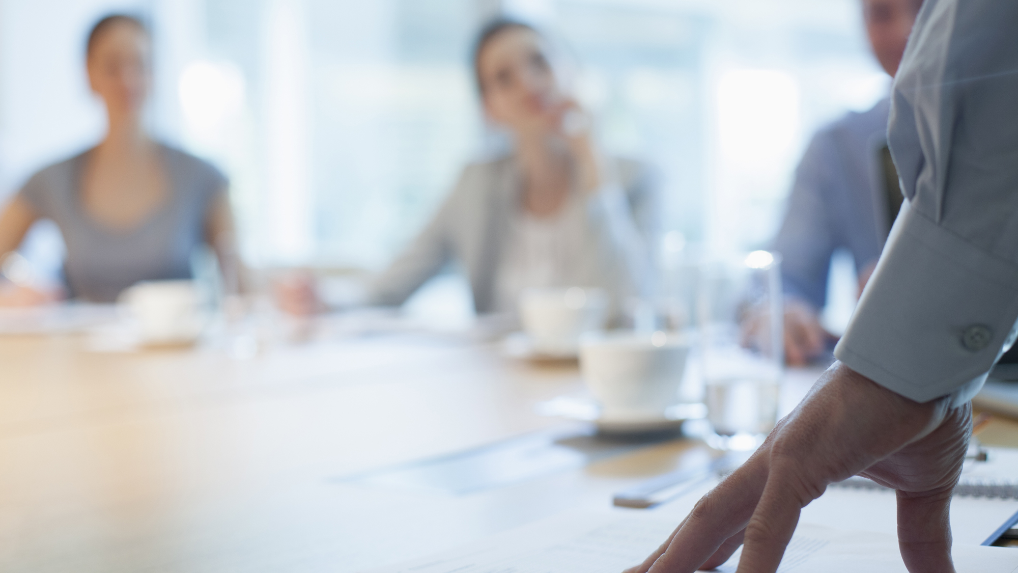 unfocussed image of men and women in a meeting