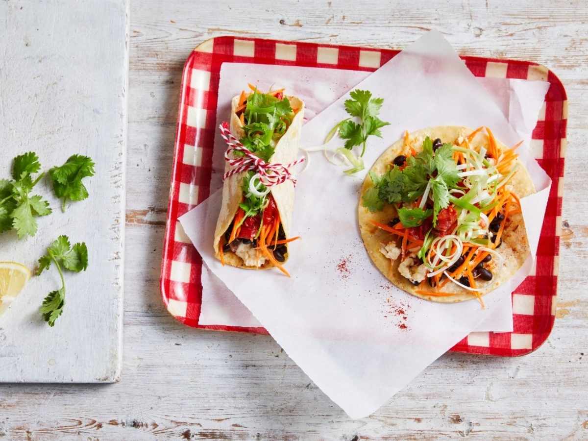 Breakfast tacos served on a plate with assorted fillings