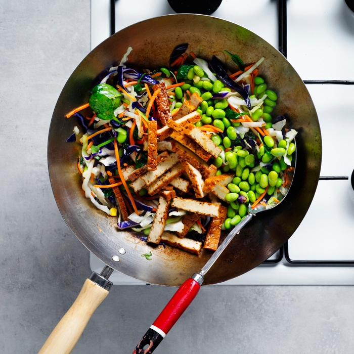 Vegetable mix with edamame and tofu in a wok