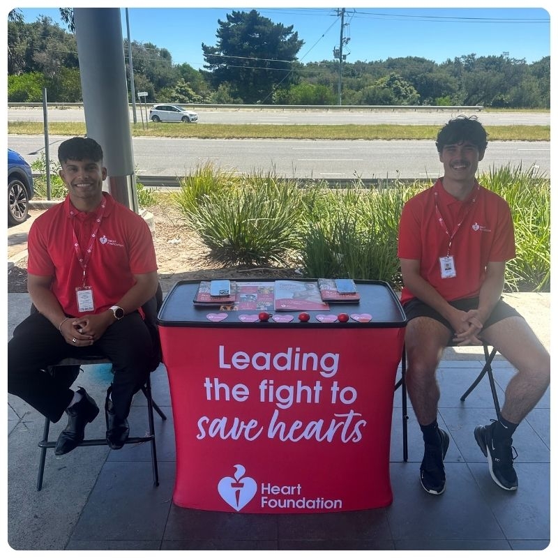 Two friendly Heart Foundation face-to-face fundraisers sitting outside a supermarket