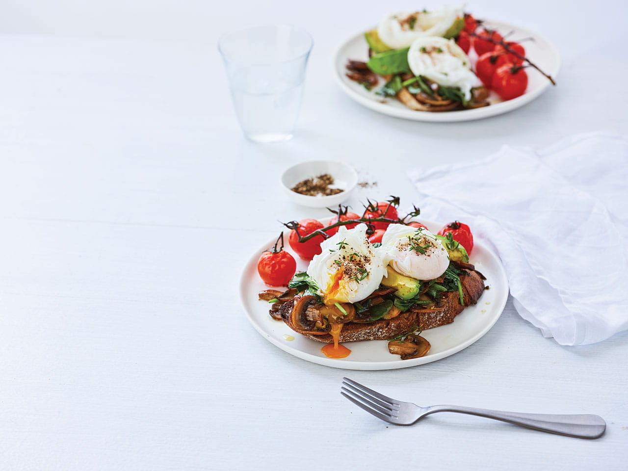 A plate of Poached eggs with spinach and mushroom