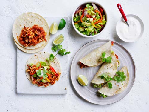 Serving shredded tofu tacos