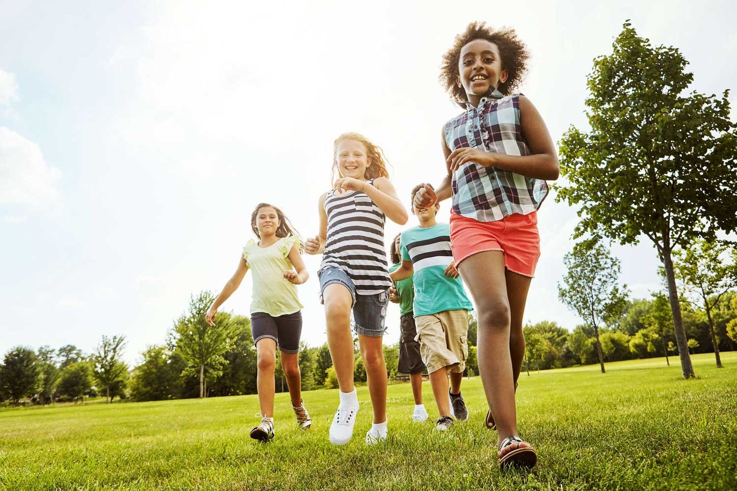 Group of children running together in a park