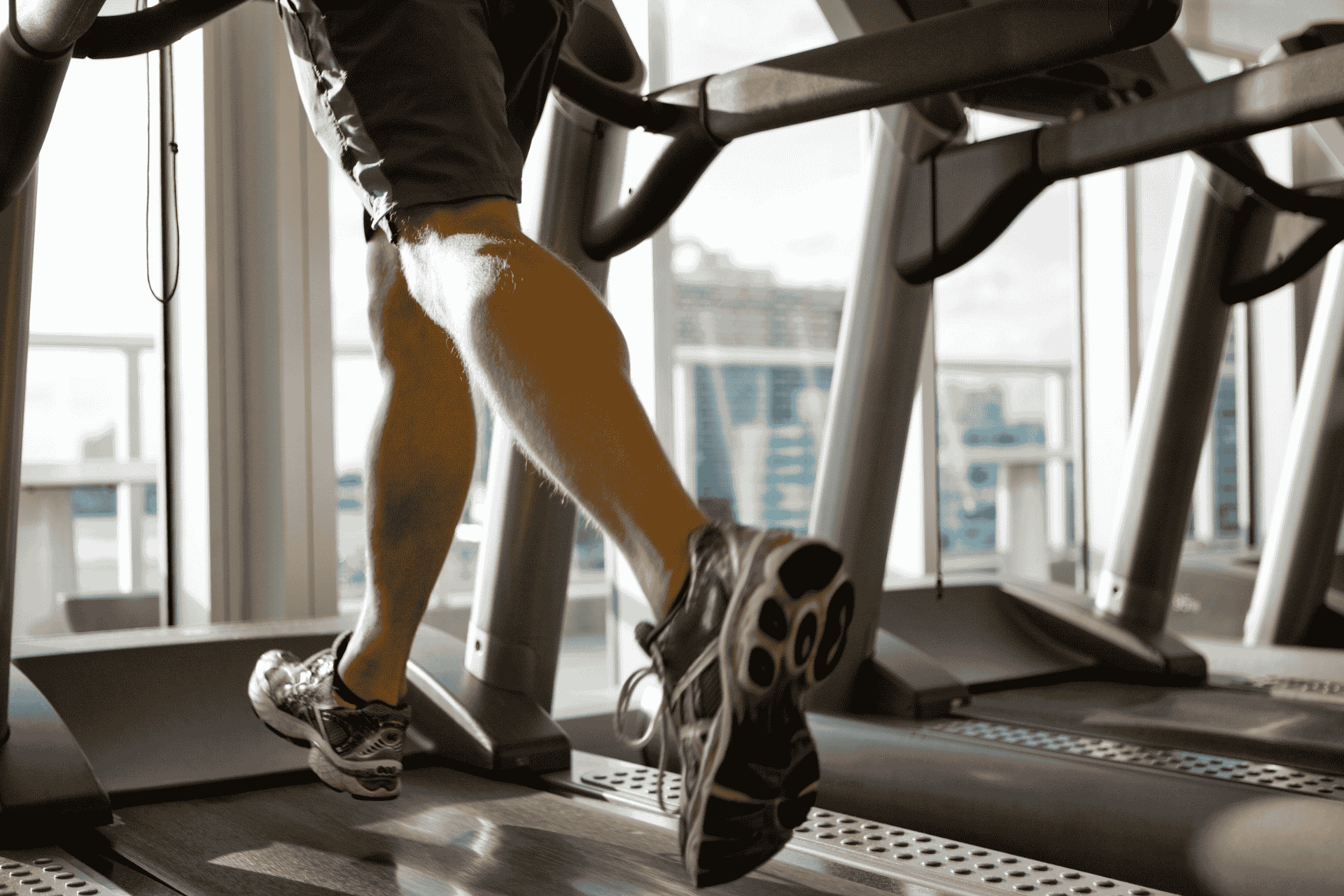 A man running on a treadmill at the gym