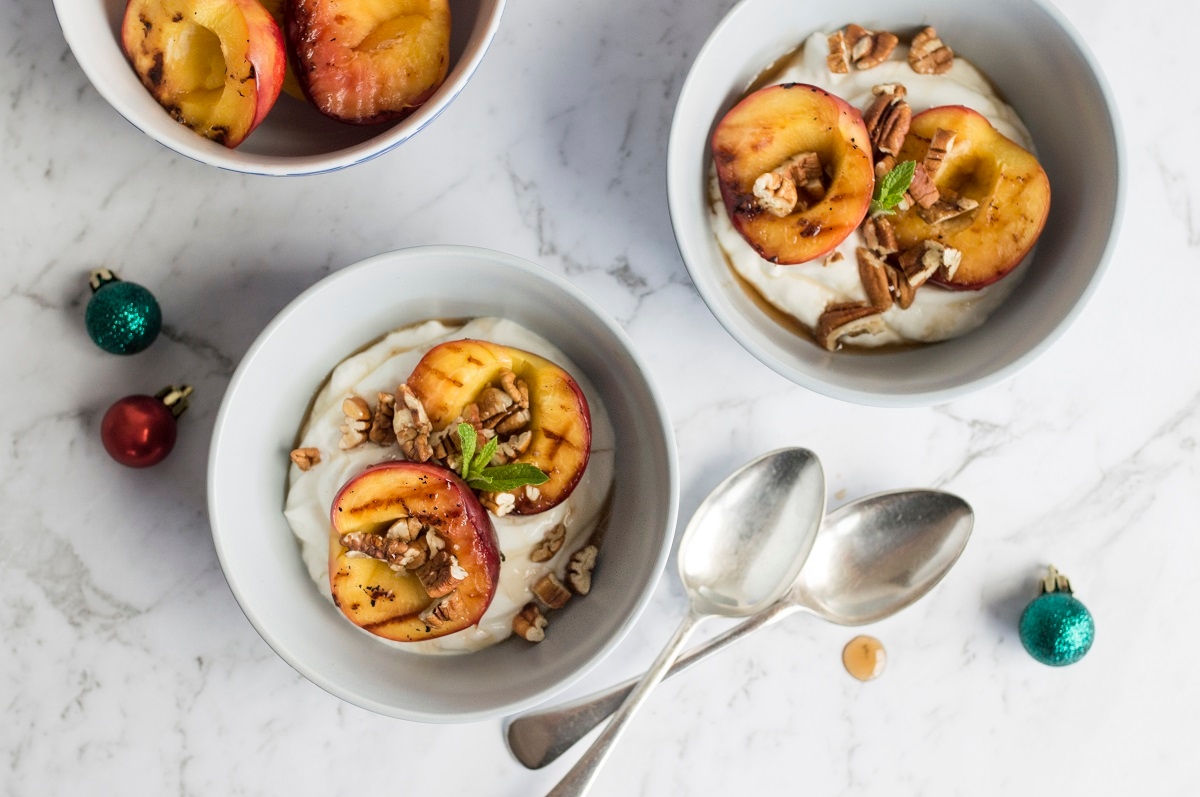  nutritious and appetizing dish featuring peach and yogurt, complemented by a sweet touch of honey and a crunchy twist of pecans