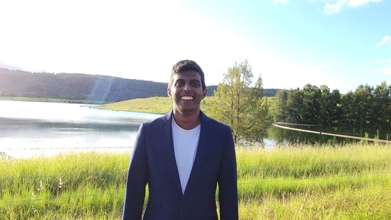 Dr Prajith Jeyaprakash standing in front of a lake smiling