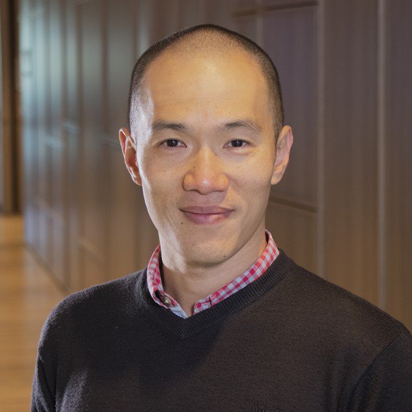 Jason Wu wearing a sweater and black shirt, looking stylish and confident.