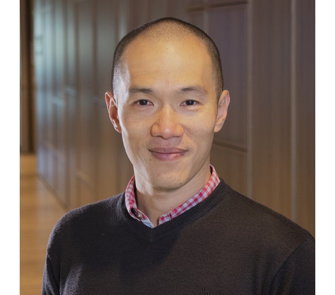 Jason Wu wearing a sweater and black shirt, looking stylish and confident.