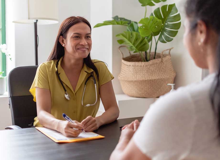 Female health professional is talking to patient during heart health check