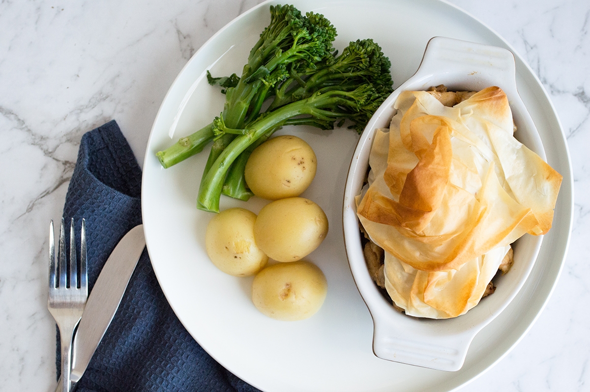 A delicious meal of pie, potatoes, and broccoli on a plate