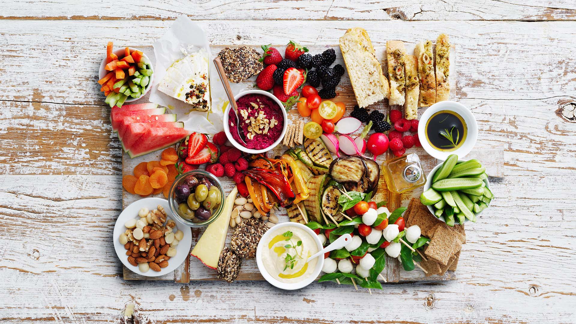 Overhead view of a table spread with vibrant selection of finger foods 