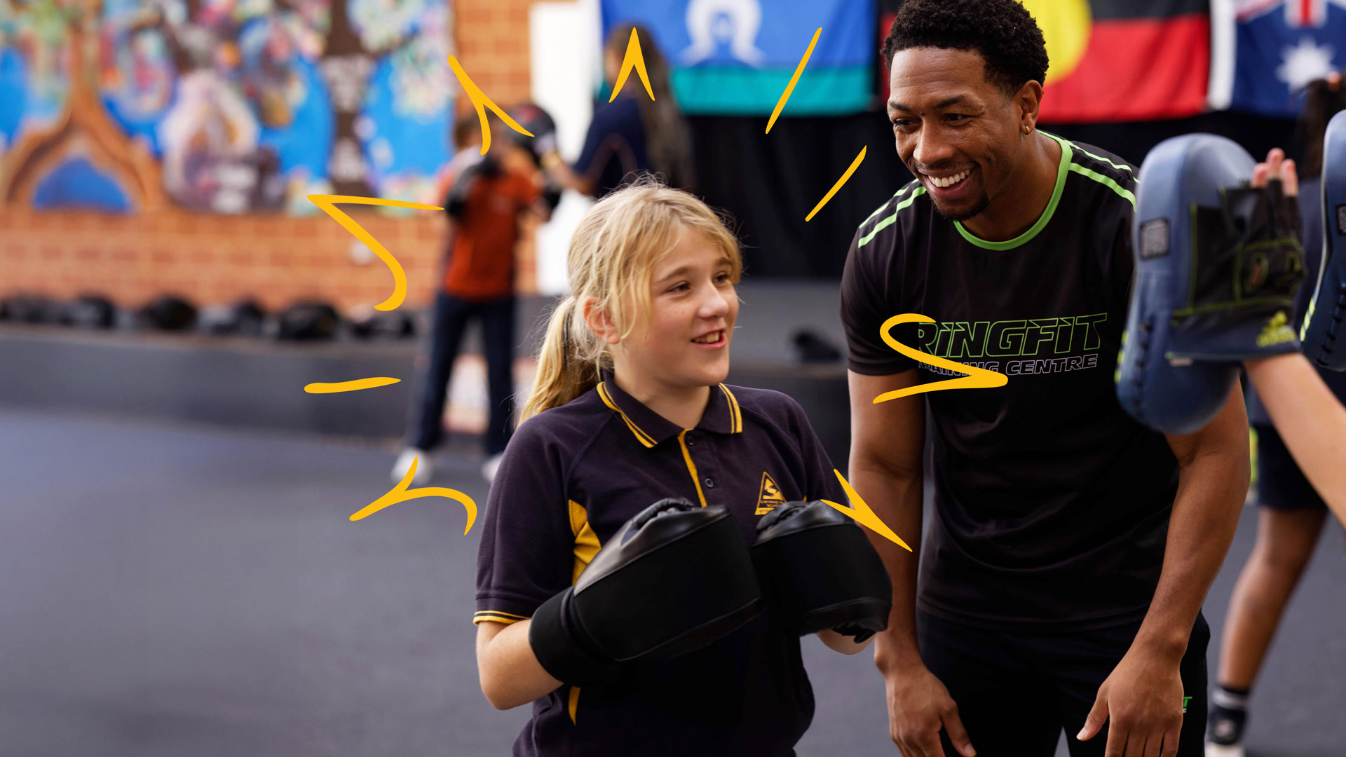 Champ builders coach and student with boxing gloves
