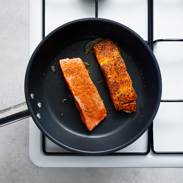 Salmon frying in a pan
