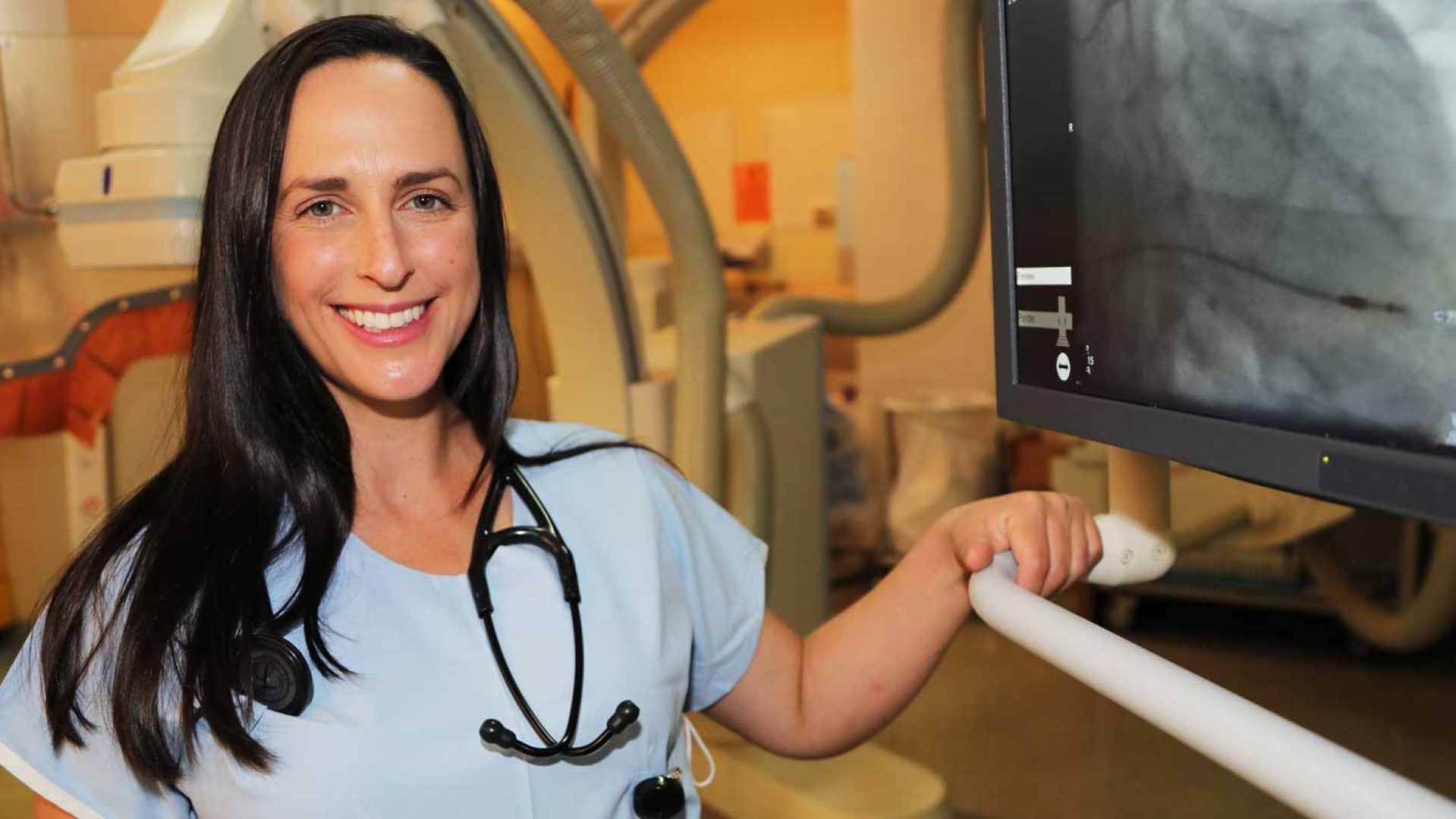 doctor with sthethoscope and monitor screen