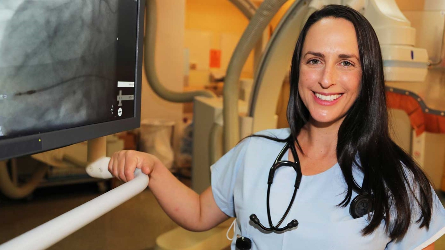 doctor with sthethoscope and monitor screen