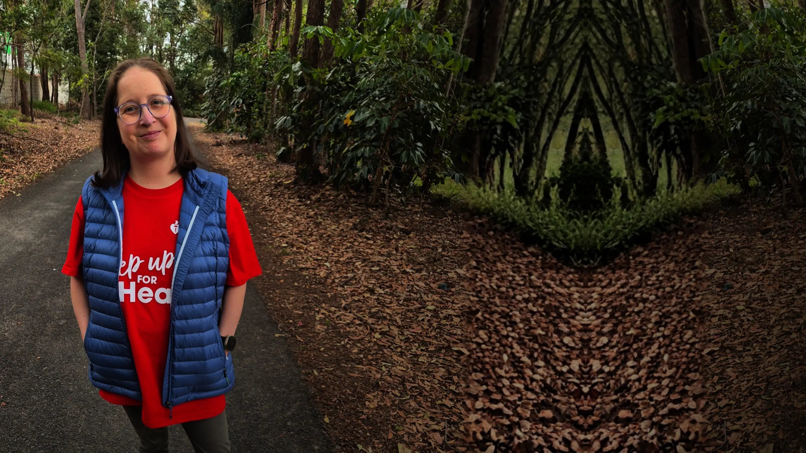 Taiya smiling standing in a park, on a pathway, wearing blue vest with red t-shirt